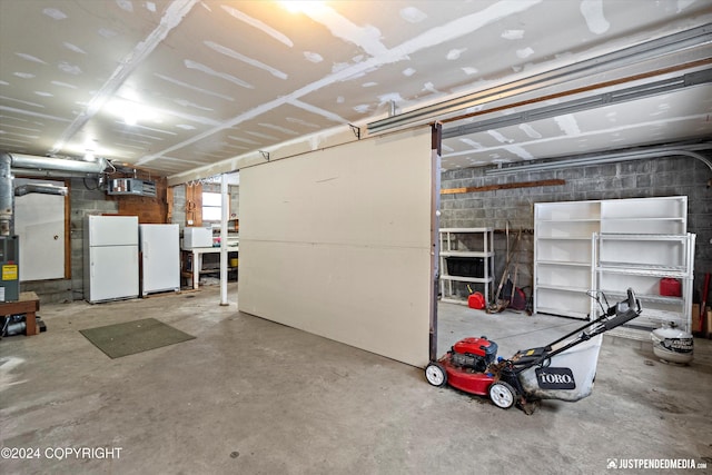 19237 Beverly Ave, Chugiak, AK 99567 - garage with freestanding refrigerator and concrete block wall