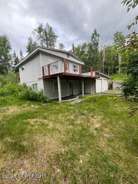 19237 Beverly Ave, Chugiak, AK 99567 - rear view of house with a deck, an attached garage, and a lawn