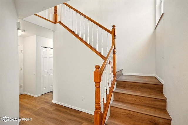 10270 Sextant Cir, Anchorage, AK 99515 - stairs featuring wood finished floors, baseboards, and a high ceiling