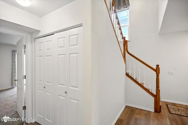 10270 Sextant Cir, Anchorage, AK 99515 - hallway featuring stairway, wood finished floors, and baseboards