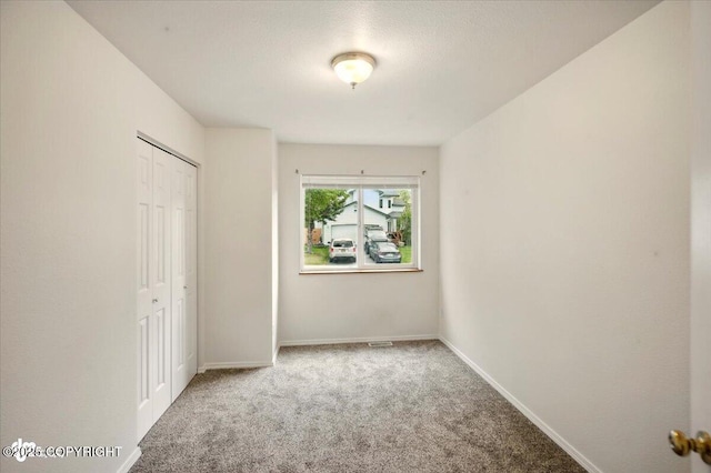 10270 Sextant Cir, Anchorage, AK 99515 - unfurnished bedroom featuring carpet flooring, a closet, and baseboards