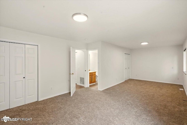 10270 Sextant Cir, Anchorage, AK 99515 - unfurnished bedroom with carpet, baseboards, and multiple closets
