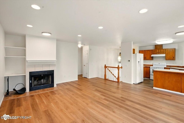 10270 Sextant Cir, Anchorage, AK 99515 - unfurnished living room with light wood-style flooring, a fireplace, and recessed lighting