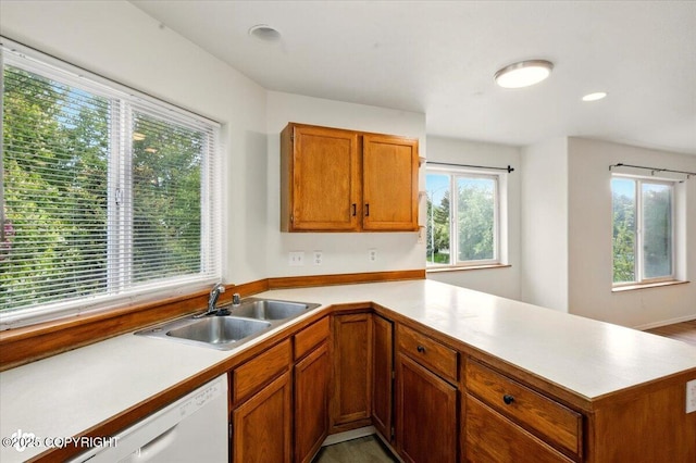 10270 Sextant Cir, Anchorage, AK 99515 - kitchen with a sink, light countertops, brown cabinetry, a peninsula, and white dishwasher