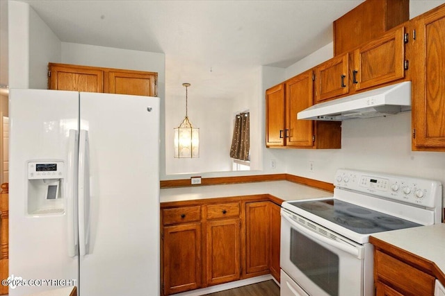 10270 Sextant Cir, Anchorage, AK 99515 - kitchen featuring white appliances, under cabinet range hood, light countertops, brown cabinetry, and pendant lighting
