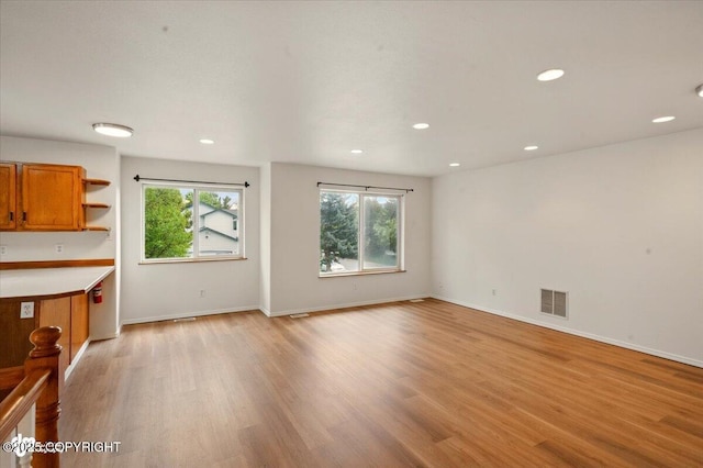 10270 Sextant Cir, Anchorage, AK 99515 - unfurnished living room with light wood-style flooring, recessed lighting, and baseboards
