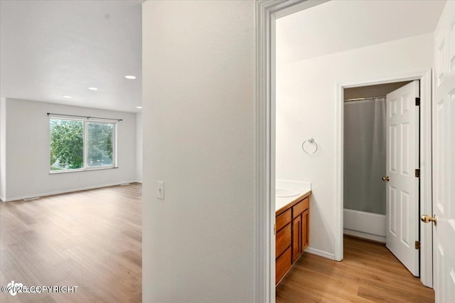 10270 Sextant Cir, Anchorage, AK 99515 - bathroom featuring vanity, wood finished floors, baseboards, recessed lighting, and a shower