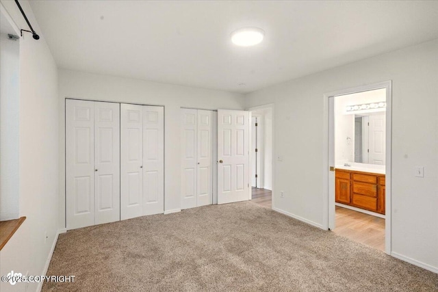 10270 Sextant Cir, Anchorage, AK 99515 - unfurnished bedroom featuring light carpet, multiple closets, baseboards, and connected bathroom