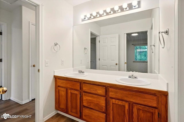 10270 Sextant Cir, Anchorage, AK 99515 - bathroom featuring double vanity, wood finished floors, and baseboards