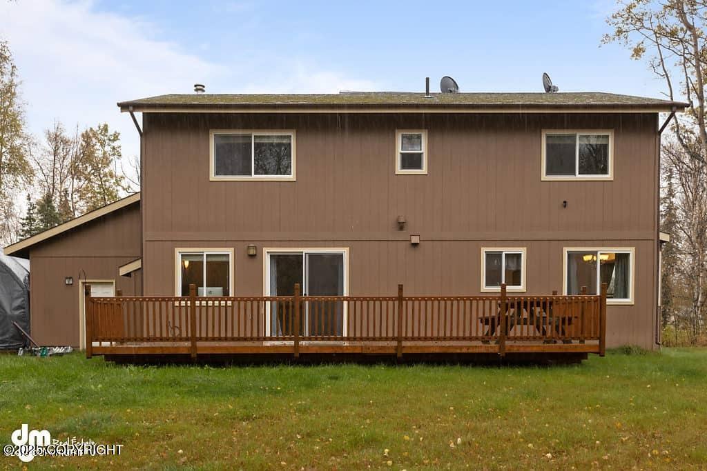7693 E Aspen Ridge Rd, Wasilla, AK 99654 - back of property featuring a wooden deck and a lawn