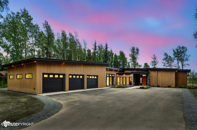 1308 Cunningham Ct, Kenai, AK 99611 - garage at dusk with asphalt driveway