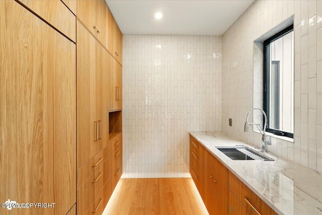 1308 Cunningham Ct, Kenai, AK 99611 - kitchen featuring a sink, light stone countertops, light wood finished floors, tile walls, and modern cabinets