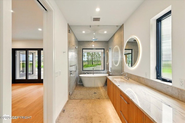 1308 Cunningham Ct, Kenai, AK 99611 - full bathroom featuring a freestanding bath, double vanity, and recessed lighting