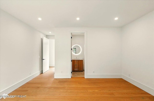 1308 Cunningham Ct, Kenai, AK 99611 - empty room with recessed lighting, light wood finished floors, baseboards, and a sink