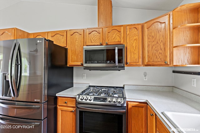 4470 E Birchwood Dr, Wasilla, AK 99654 - kitchen with appliances with stainless steel finishes, light countertops, open shelves, vaulted ceiling, and brown cabinetry