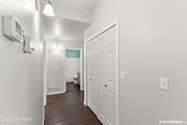 4470 E Birchwood Dr, Wasilla, AK 99654 - hall featuring dark wood-type flooring, baseboards, and a textured wall