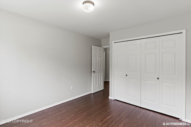 4470 E Birchwood Dr, Wasilla, AK 99654 - unfurnished bedroom featuring dark wood-style floors, baseboards, and a closet
