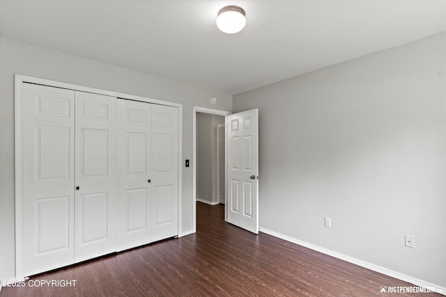 4470 E Birchwood Dr, Wasilla, AK 99654 - unfurnished bedroom featuring dark wood-type flooring, baseboards, and a closet