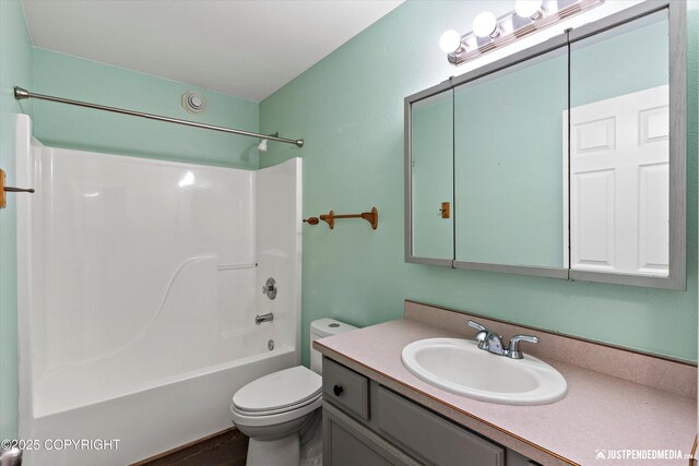 4470 E Birchwood Dr, Wasilla, AK 99654 - full bath featuring vanity, toilet, shower / washtub combination, and wood finished floors