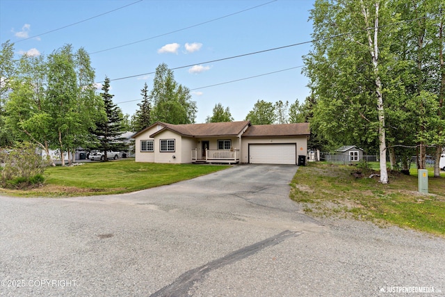 4470 E Birchwood Dr, Wasilla, AK 99654 - ranch-style house featuring a garage, asphalt driveway, a front lawn, stucco siding, and covered porch