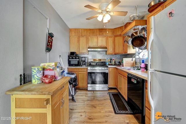 7510 Peck Ave, Anchorage, AK 99504 - kitchen with freestanding refrigerator, gas range, black dishwasher, a sink, and wooden counters