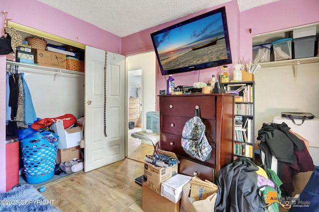7510 Peck Ave, Anchorage, AK 99504 - bedroom with wood finished floors, a textured ceiling, and a closet