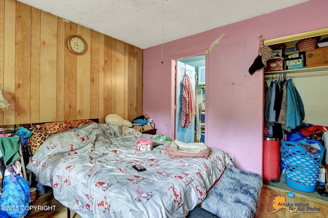 7510 Peck Ave, Anchorage, AK 99504 - bedroom with a closet, wooden walls, and a textured ceiling
