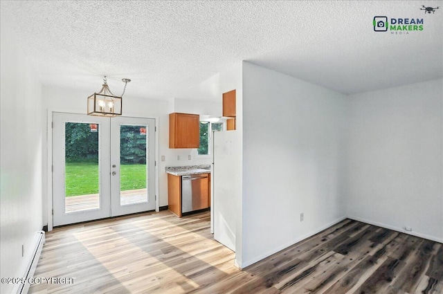1918 Juneau Dr, Anchorage, AK 99501 - kitchen with dishwasher, a baseboard radiator, brown cabinetry, light wood-style floors, and a textured ceiling