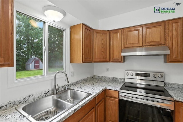 1918 Juneau Dr, Anchorage, AK 99501 - kitchen featuring stainless steel range with electric cooktop, ventilation hood, and brown cabinetry