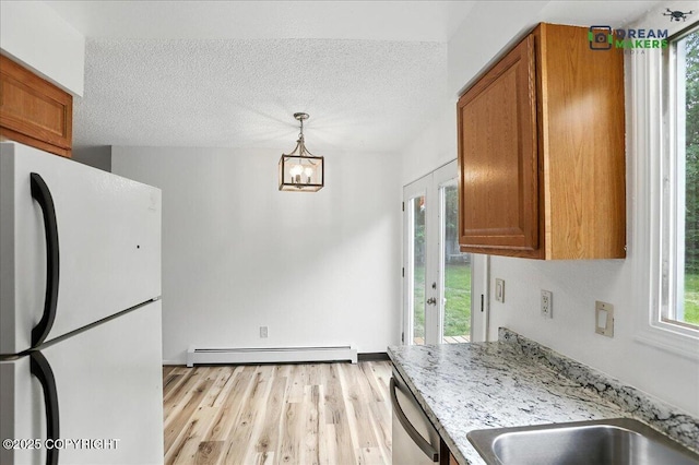 1918 Juneau Dr, Anchorage, AK 99501 - kitchen with freestanding refrigerator, a baseboard radiator, dishwasher, brown cabinets, and a textured ceiling