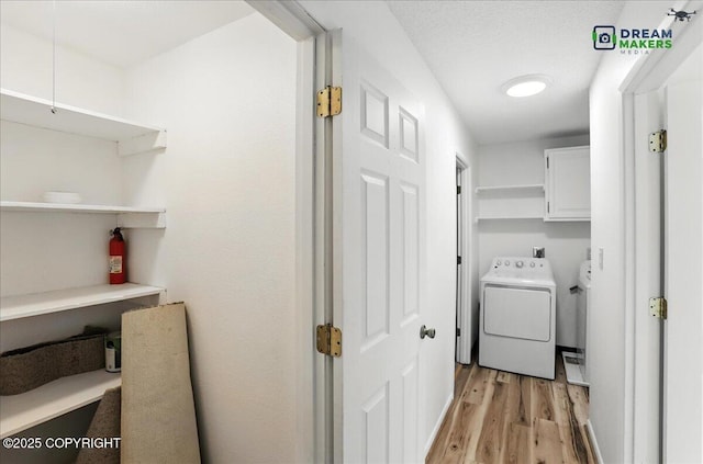 1918 Juneau Dr, Anchorage, AK 99501 - laundry room featuring cabinet space, separate washer and dryer, and light wood finished floors