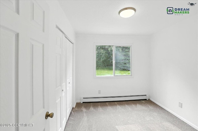 1918 Juneau Dr, Anchorage, AK 99501 - unfurnished bedroom featuring baseboard heating, carpet floors, and a closet