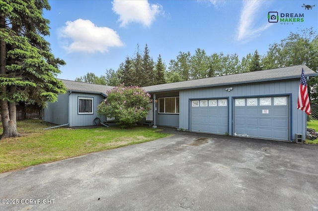 1918 Juneau Dr, Anchorage, AK 99501 - view of front facade featuring driveway, a front yard, and an attached garage