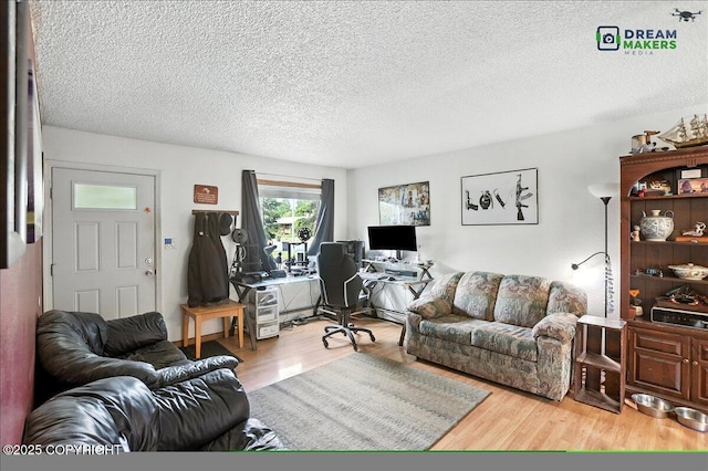 1918 Juneau Dr, Anchorage, AK 99501 - living area with a desk, wood finished floors, and a textured ceiling