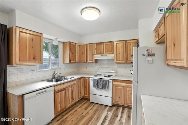 1918 Juneau Dr, Anchorage, AK 99501 - kitchen with white appliances, under cabinet range hood, light wood finished floors, and light countertops