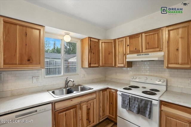 1918 Juneau Dr, Anchorage, AK 99501 - kitchen with under cabinet range hood, white appliances, light countertops, and backsplash