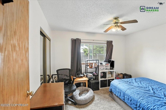 1918 Juneau Dr, Anchorage, AK 99501 - carpeted bedroom featuring a desk, a textured ceiling, a closet, and ceiling fan