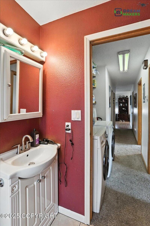 1918 Juneau Dr, Anchorage, AK 99501 - bathroom featuring washer and dryer, vanity, and a textured wall