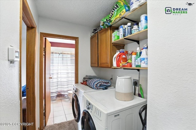 1918 Juneau Dr, Anchorage, AK 99501 - laundry area with separate washer and dryer, a textured ceiling, cabinet space, a textured wall, and light tile patterned floors