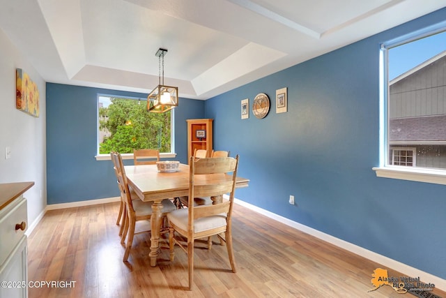 18924 Third St, Eagle River, AK 99577 - dining area with a raised ceiling, light wood-style flooring, and a chandelier