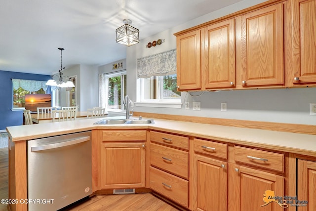 18924 Third St, Eagle River, AK 99577 - kitchen with dishwasher, a chandelier, light wood-style flooring, and light countertops