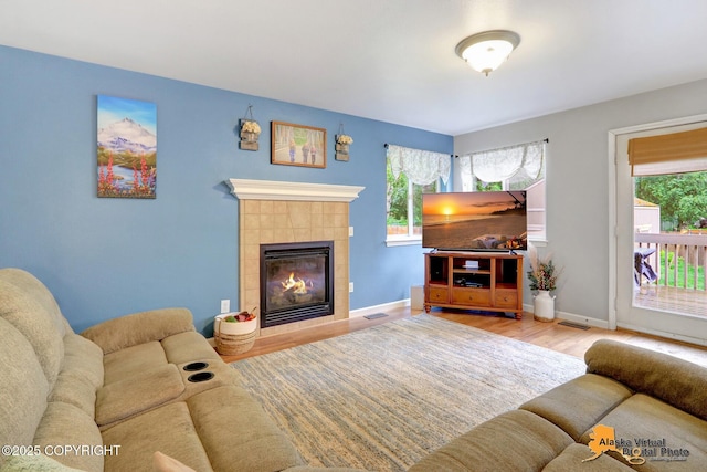 18924 Third St, Eagle River, AK 99577 - living area featuring wood finished floors and a tiled fireplace