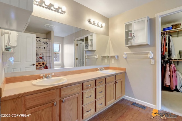 18924 Third St, Eagle River, AK 99577 - full bathroom with double vanity, wood finished floors, and a spacious closet