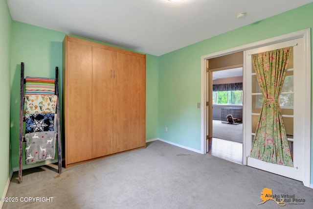18924 Third St, Eagle River, AK 99577 - unfurnished bedroom with light colored carpet and baseboards