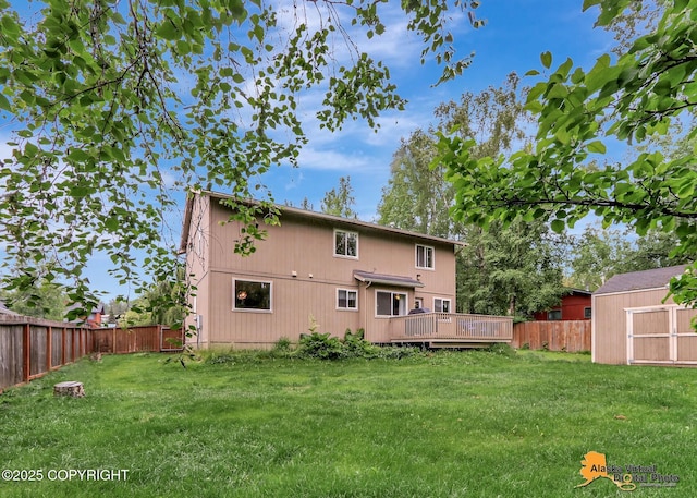 18924 Third St, Eagle River, AK 99577 - rear view of property featuring a wooden deck, a fenced backyard, and a storage unit