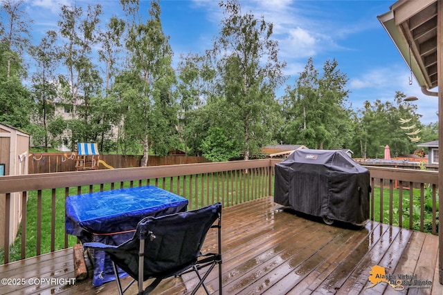18924 Third St, Eagle River, AK 99577 - wooden terrace with a grill, a fenced backyard, and a playground
