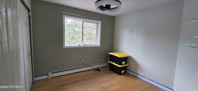 6905 Cape Lisburne Loop, Anchorage, AK 99504 - bedroom featuring a baseboard radiator, wood finished floors, and a closet