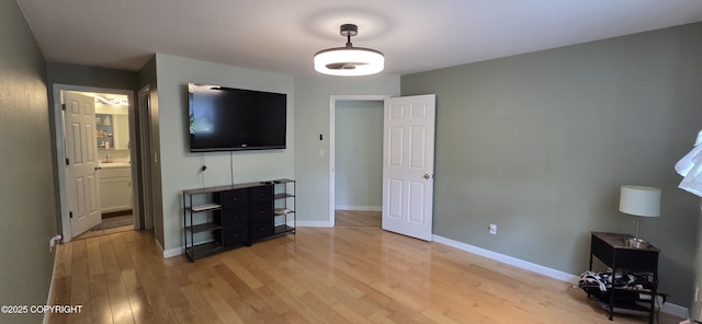 6905 Cape Lisburne Loop, Anchorage, AK 99504 - unfurnished bedroom featuring light wood-style floors, baseboards, a sink, and connected bathroom