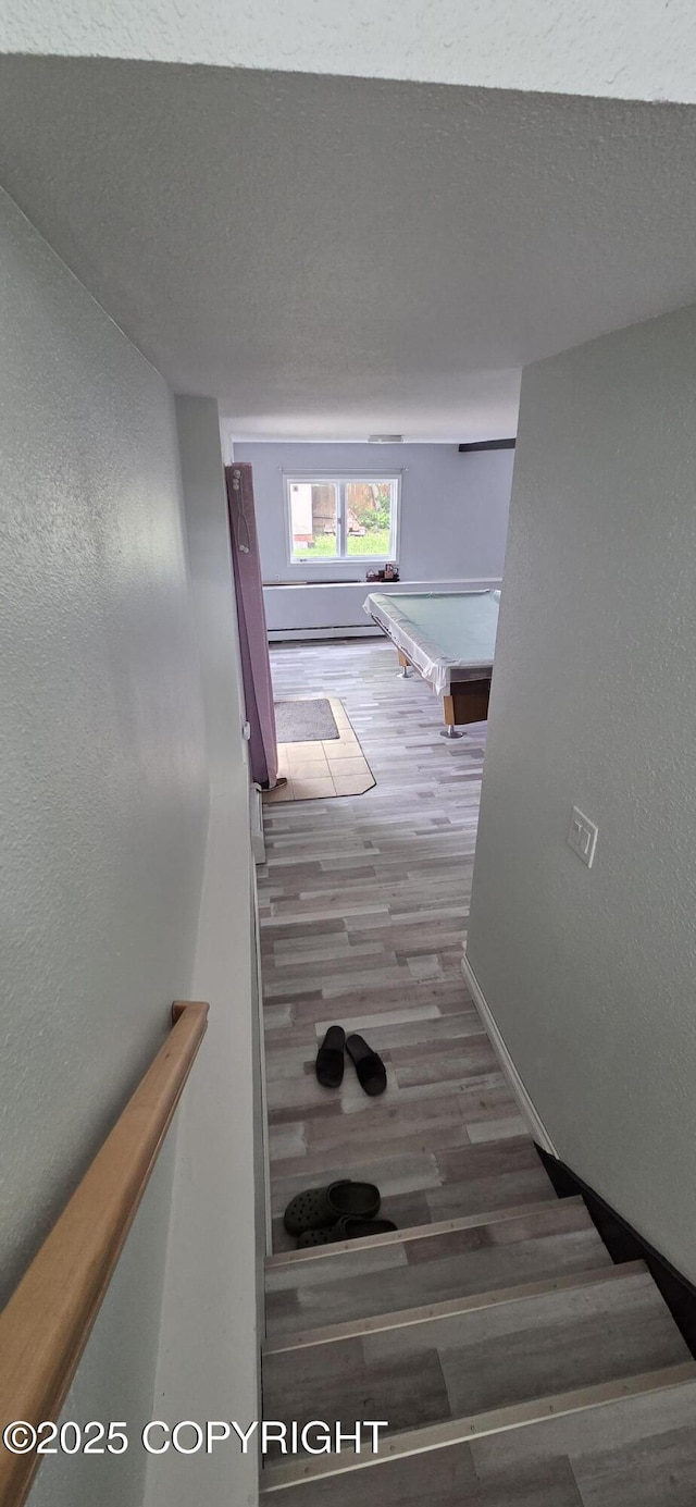 6905 Cape Lisburne Loop, Anchorage, AK 99504 - stairway with wood finished floors, baseboards, and a textured wall