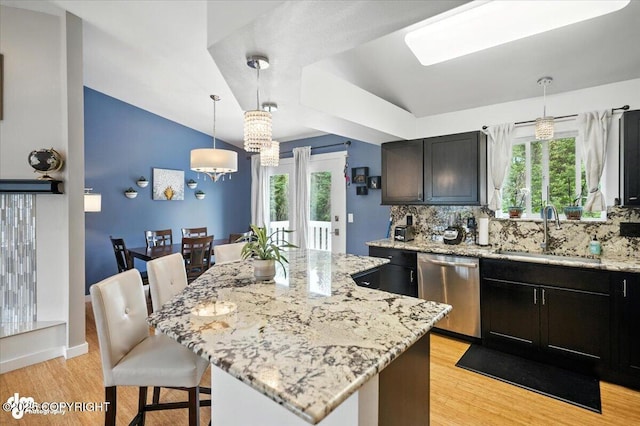 8968 Little Brook St, Anchorage, AK 99507 - kitchen featuring dishwasher, light stone countertops, a kitchen breakfast bar, and light wood-type flooring